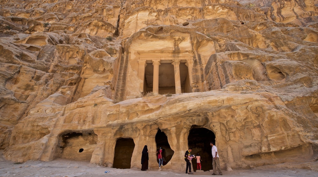 Little Petra which includes heritage architecture and a gorge or canyon as well as a small group of people