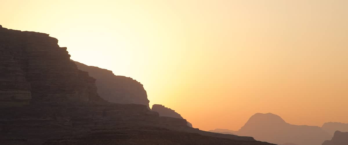 Wadi Rum which includes a sunset, desert views and a gorge or canyon