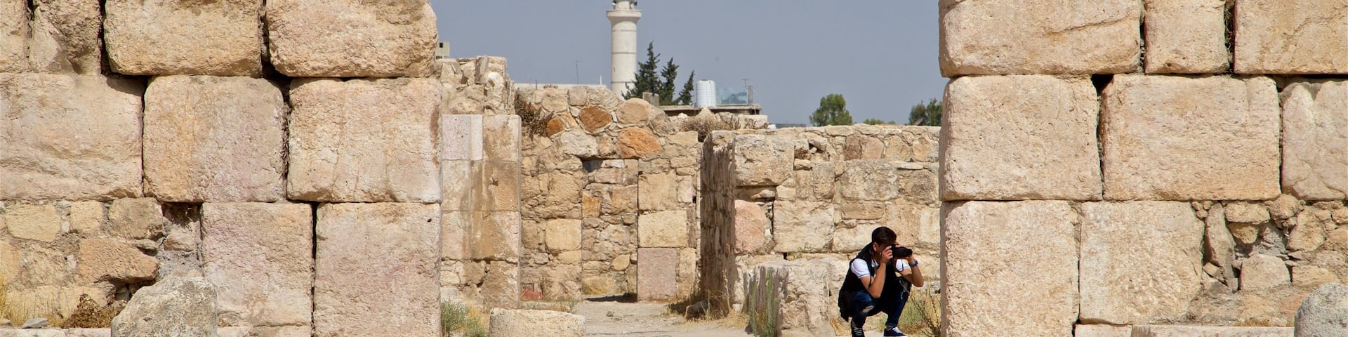 Amman Citadel showing heritage elements and building ruins as well as an individual male