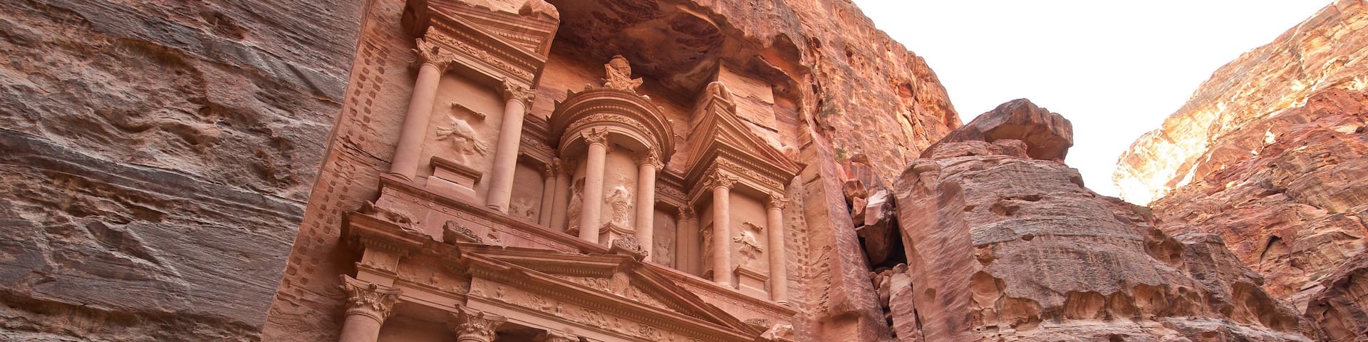 Wadi Musa featuring heritage architecture and a gorge or canyon as well as a small group of people