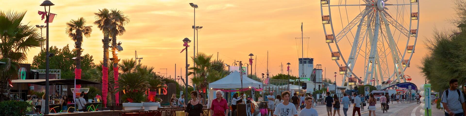 Rimini Ferris Wheel which includes a sunset as well as a small group of people