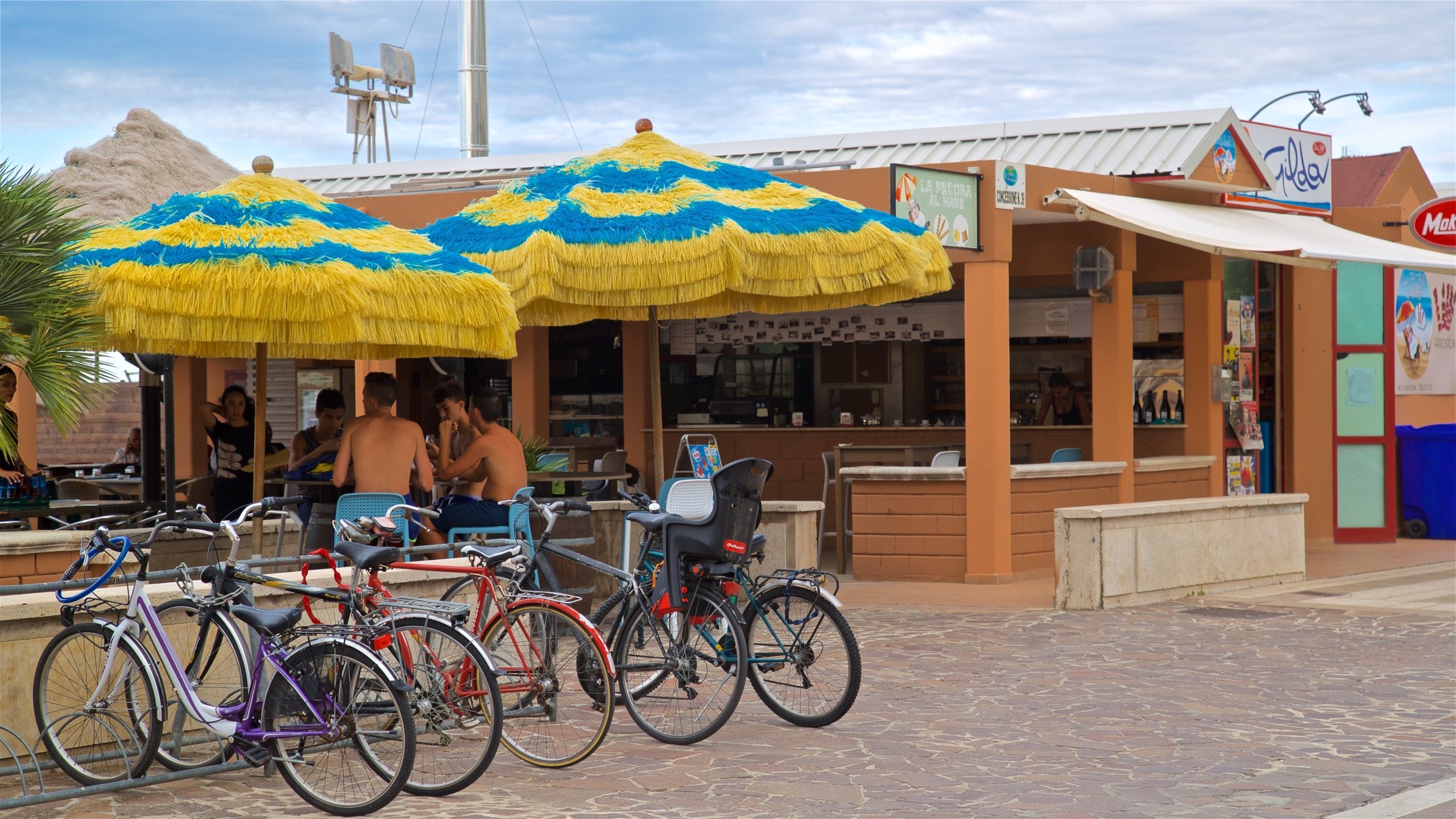 Pescara showing a beach bar as well as a small group of people