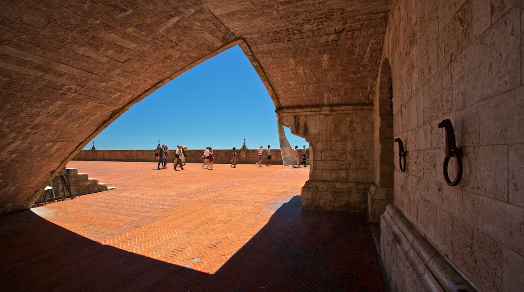 Gubbio showing heritage elements and a square or plaza as well as a small group of people