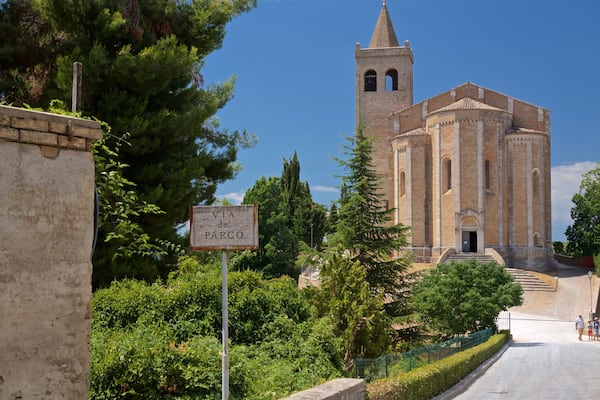 Church of Santa Maria della Rocca featuring signage and heritage architecture