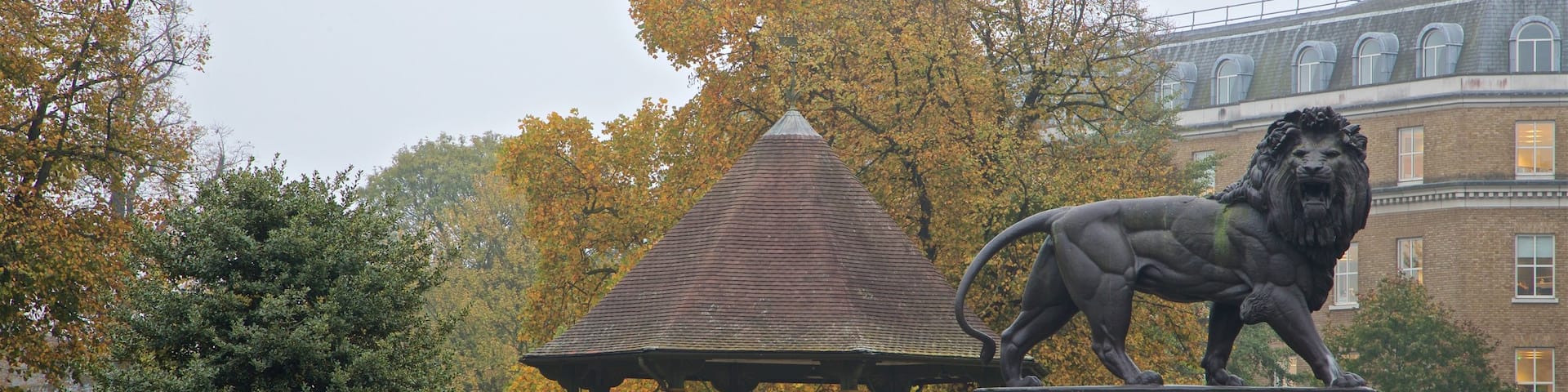 Forbury Gardens showing a park and a statue or sculpture as well as a small group of people