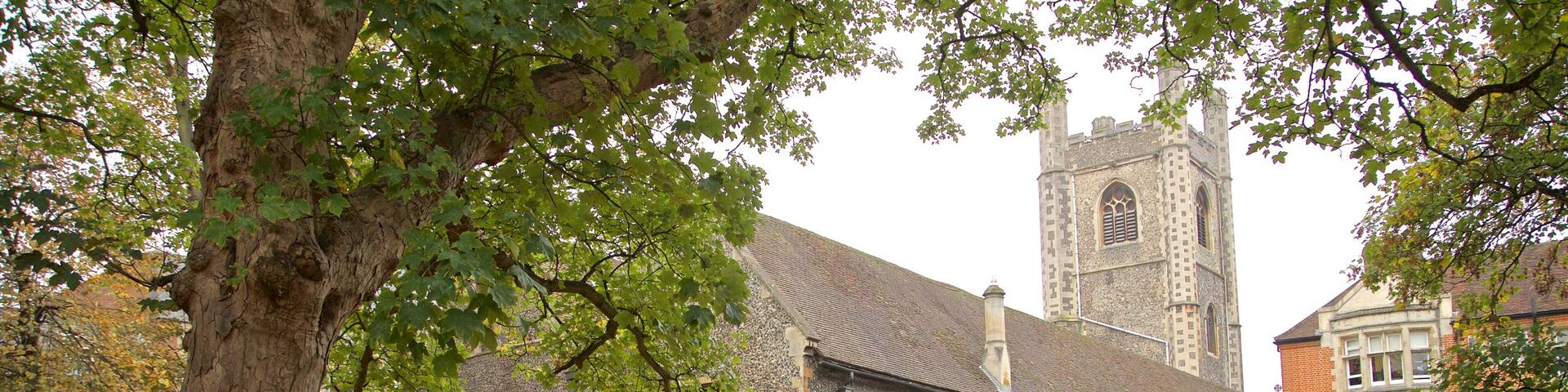 St. Laurence Church featuring heritage architecture, a cemetery and autumn leaves