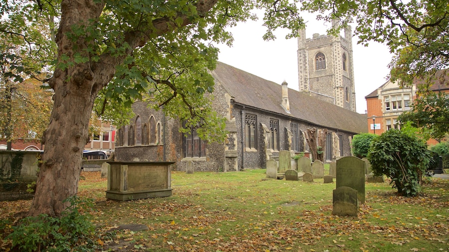 St. Laurence Church featuring heritage architecture, a cemetery and autumn leaves