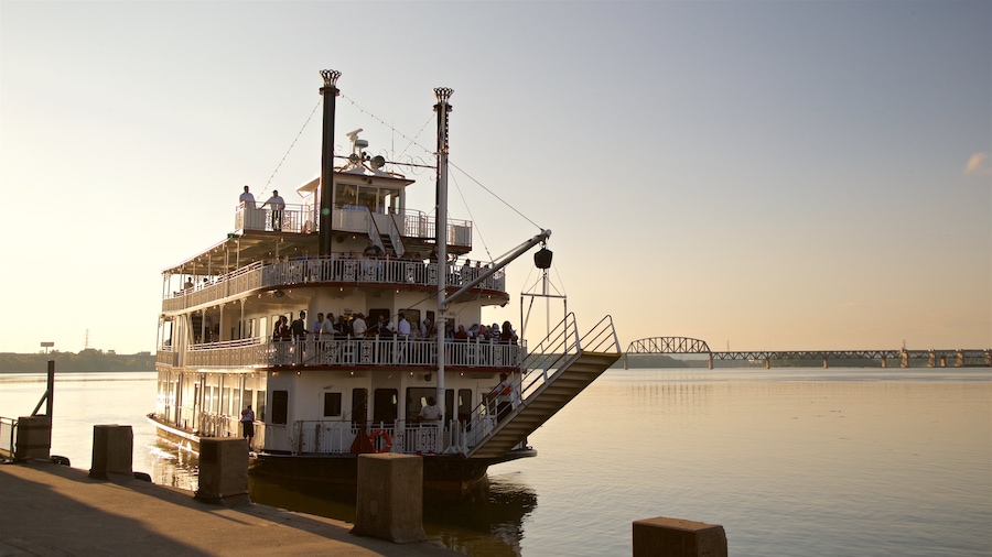Belle of Louisville showing a river or creek, a ferry and a sunset