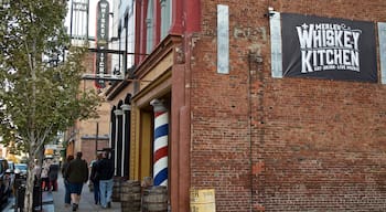 Louisville showing street scenes and signage as well as a small group of people