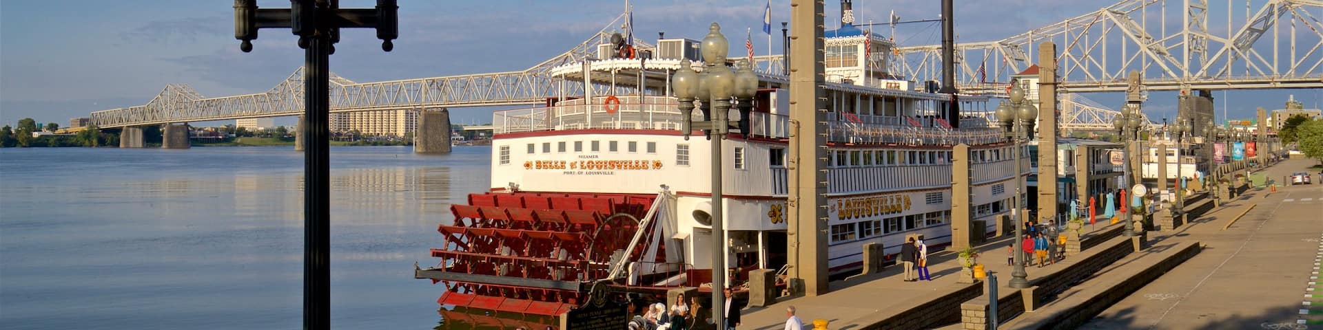 Belle of Louisville featuring a bay or harbor and a ferry as well as a small group of people