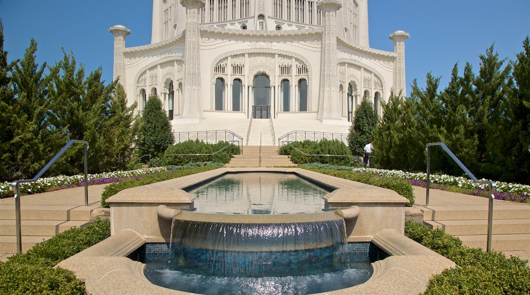 Baha\'i House of Worship which includes heritage architecture, a fountain and flowers