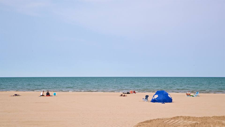 Kathy Osterman Beach featuring a sandy beach and general coastal views as well as a small group of people