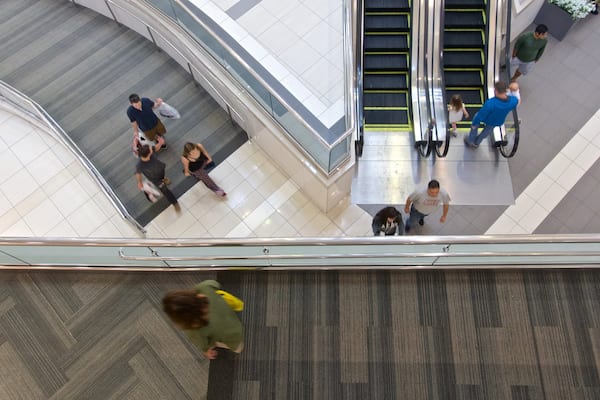Woodfield Mall showing shopping as well as a small group of people