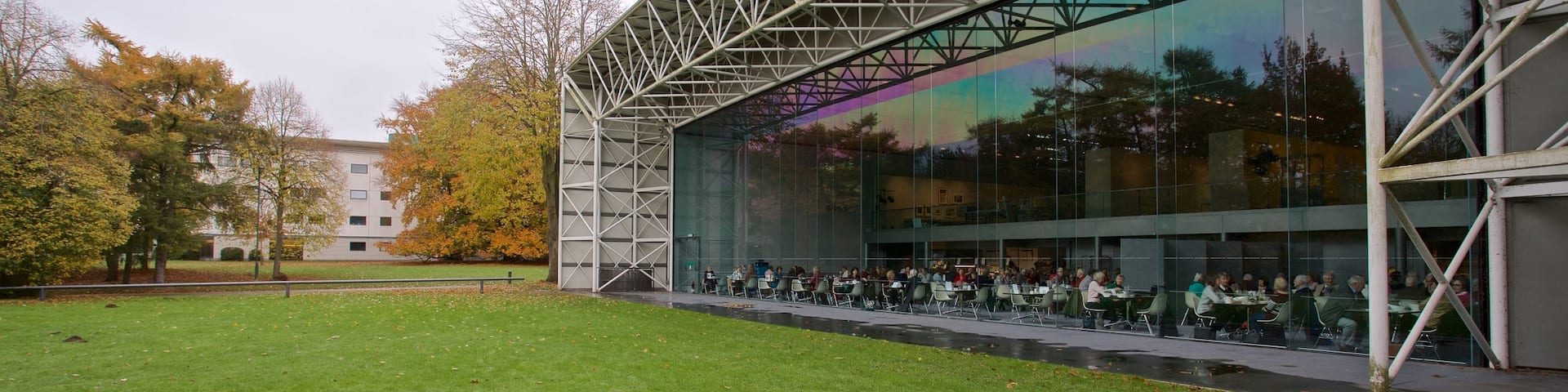 Sainsbury Centre for the Visual Arts featuring a garden and modern architecture as well as a small group of people