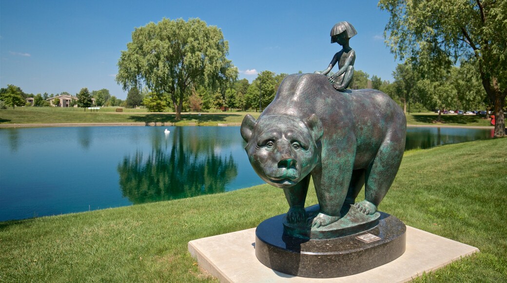 Marshall M. Fredericks Sculpture Museum featuring a garden, a lake or waterhole and outdoor art