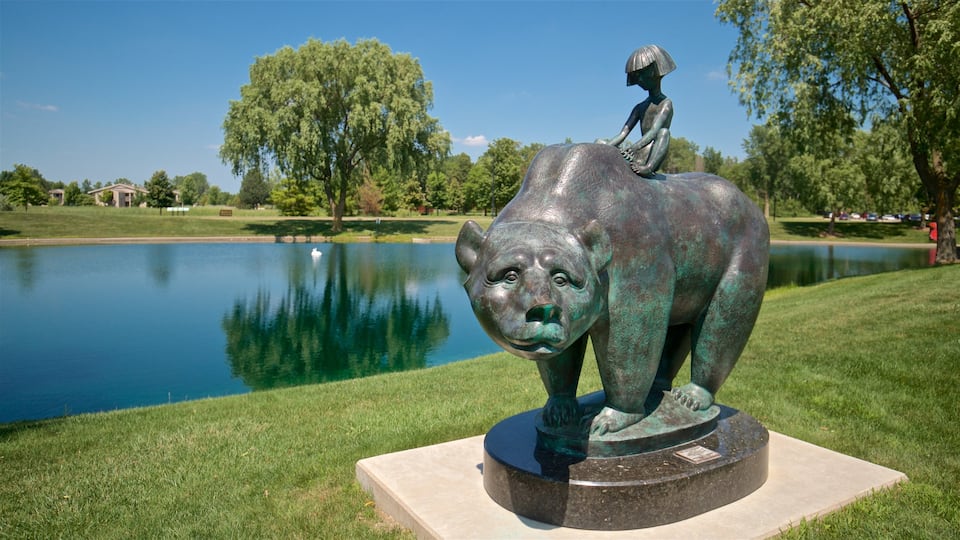 Marshall M. Fredericks Sculpture Museum featuring a garden, a lake or waterhole and outdoor art