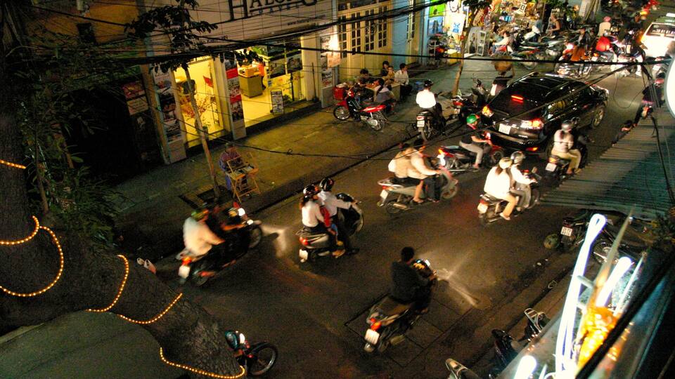 Hanoi which includes night scenes, a city and street scenes