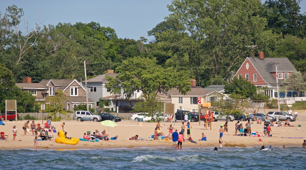 Pere Marquette Park Beach which includes a sandy beach and general coastal views as well as a large group of people