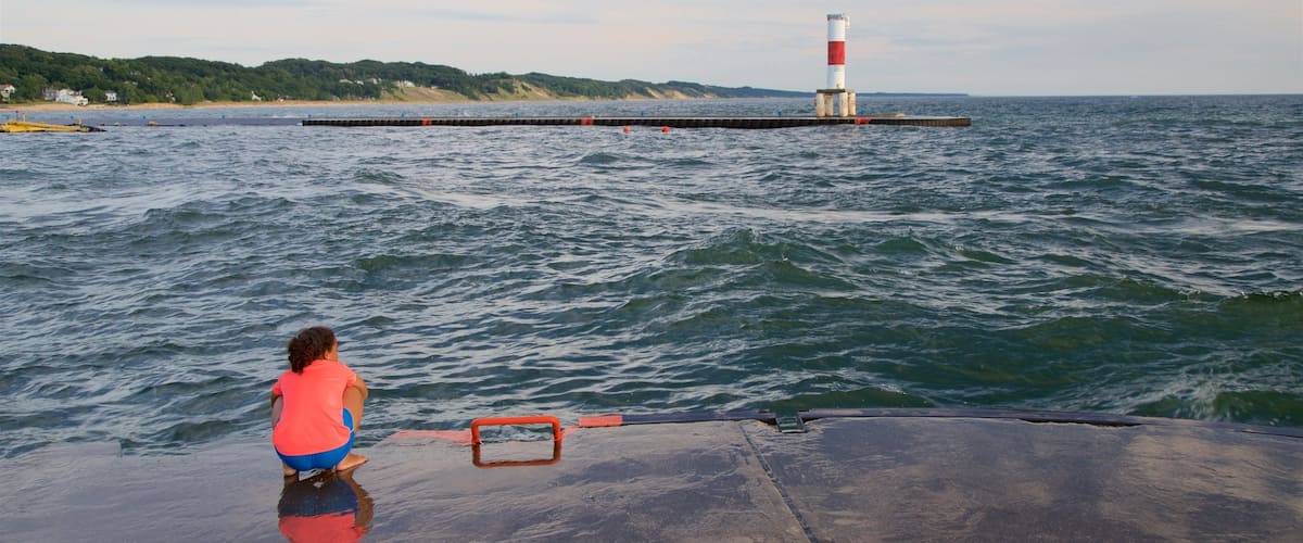 Holland featuring general coastal views and a lighthouse as well as an individual child