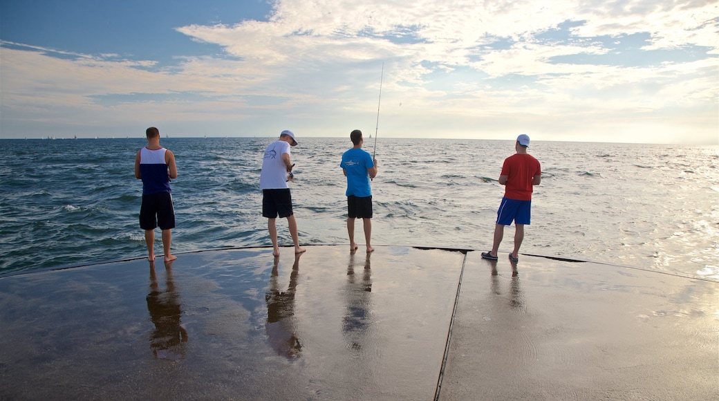 Holland featuring fishing and general coastal views as well as a small group of people