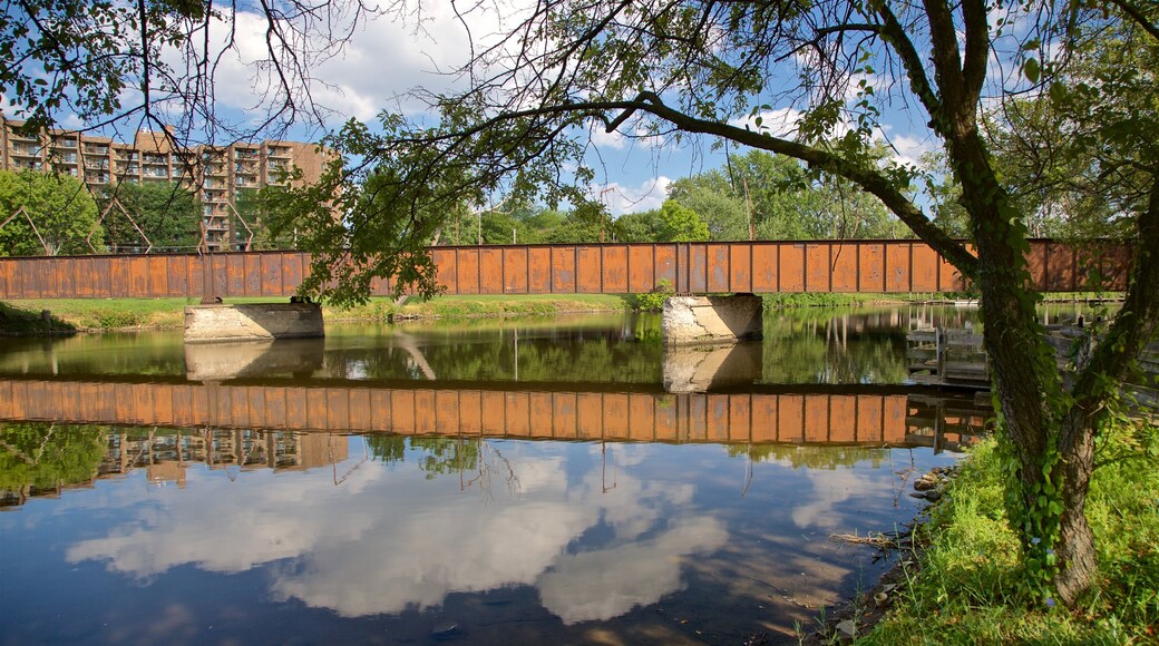 Adado Riverfront Park featuring a bridge and a river or creek