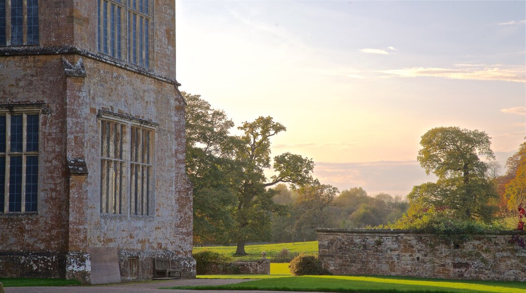 Broughton Castle which includes a park, a sunset and heritage elements