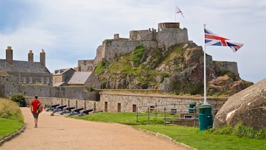 Elizabeth Castle featuring a castle as well as an individual male