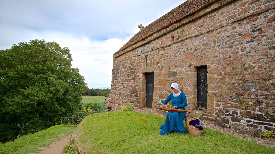 La Hougue Bie showing heritage elements and a house as well as an individual female
