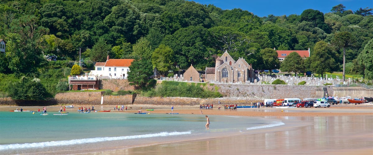 Parish Church of St. Brelade featuring a coastal town, general coastal views and a sandy beach