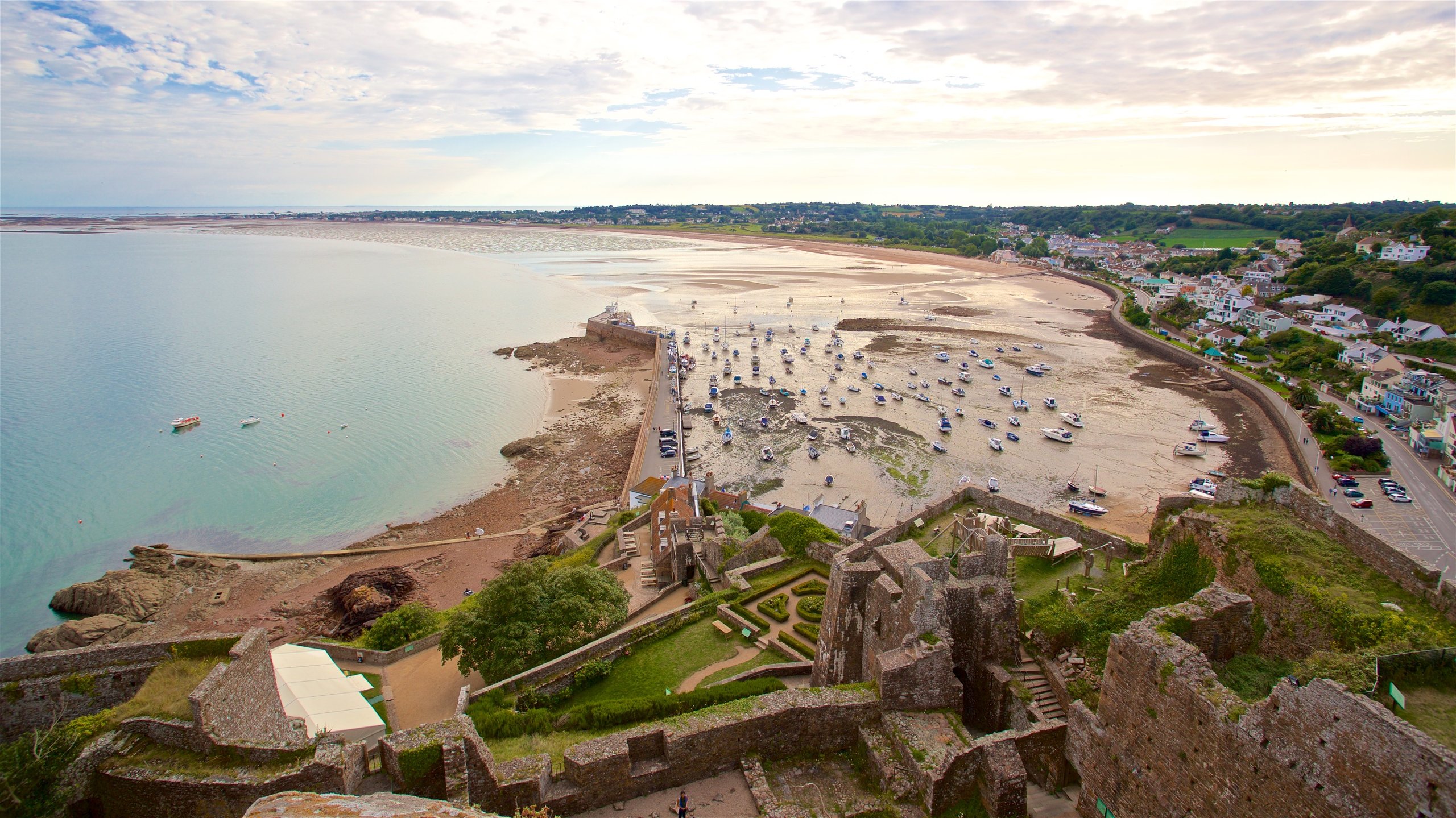 Mont Orgueil Castle featuring a ruin, a coastal town and a sandy beach