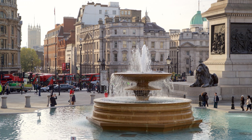 Trafalgar Square featuring a fountain and a city