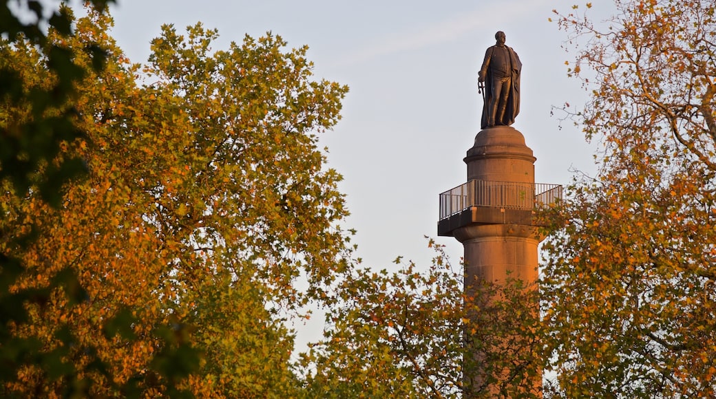 Parque de St. James que incluye una puesta de sol y una estatua o escultura
