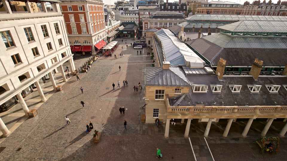 Royal Opera House which includes street scenes and a city as well as a small group of people