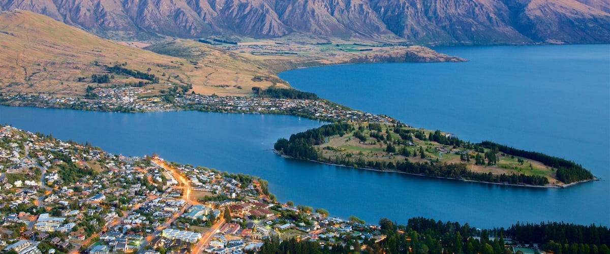 New Zealand featuring a sunset, a lake or waterhole and landscape views