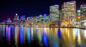 Darling Harbour which includes central business district, night scenes and a bay or harbor