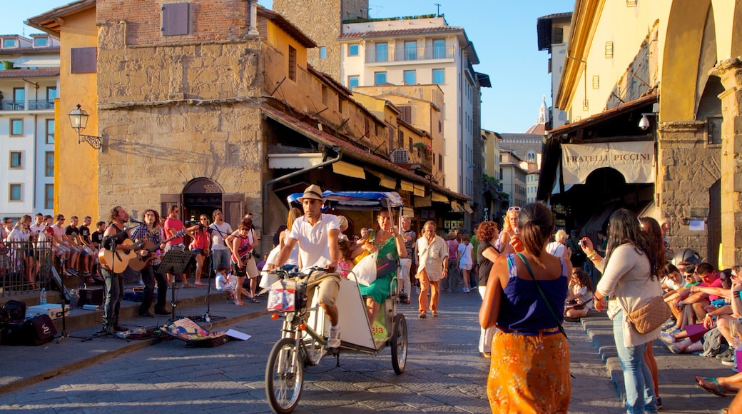 Ponte Vecchio featuring vehicle touring, a square or plaza and street performance