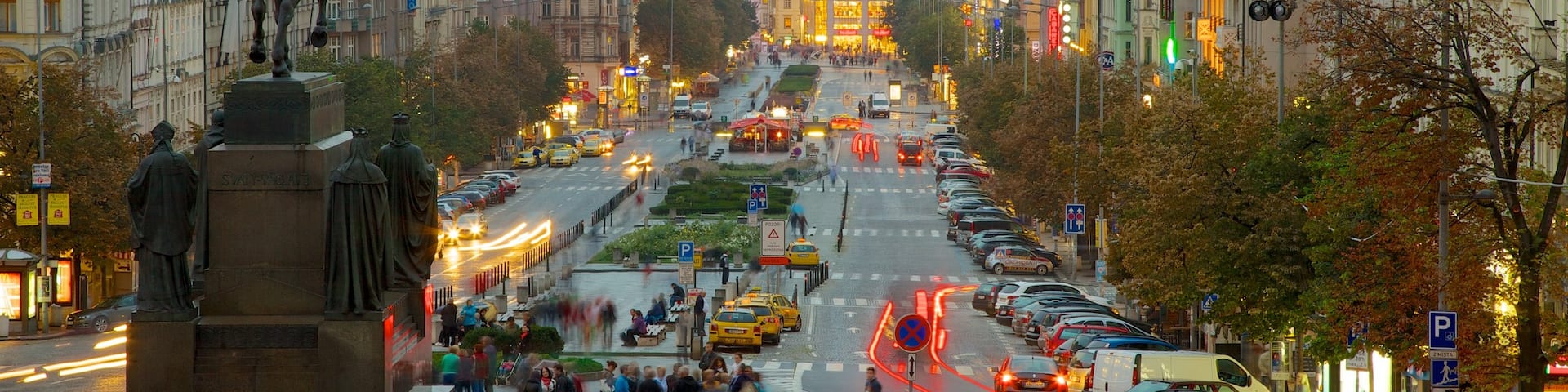 Wenceslas Square which includes a monument, a city and a statue or sculpture