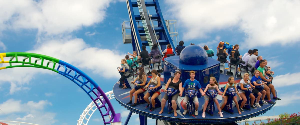 Rainbow\'s End showing rides as well as a large group of people