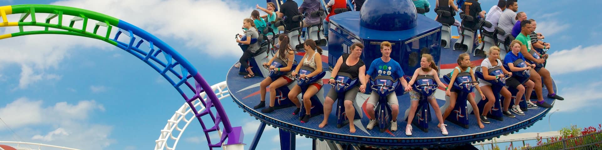 Rainbow\'s End showing rides as well as a large group of people