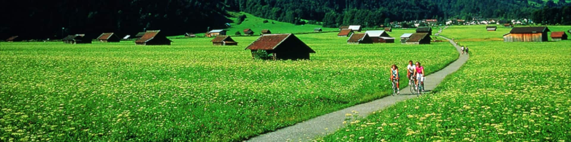 Garmisch-Partenkirchen showing mountains, a small town or village and road cycling