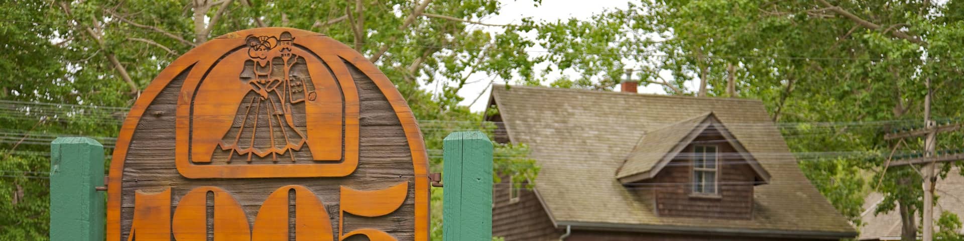 Fort Edmonton Park featuring a house, signage and a park