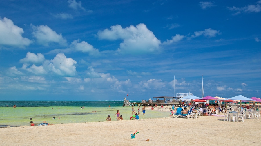 Playa Langosta showing a sandy beach, swimming and general coastal views