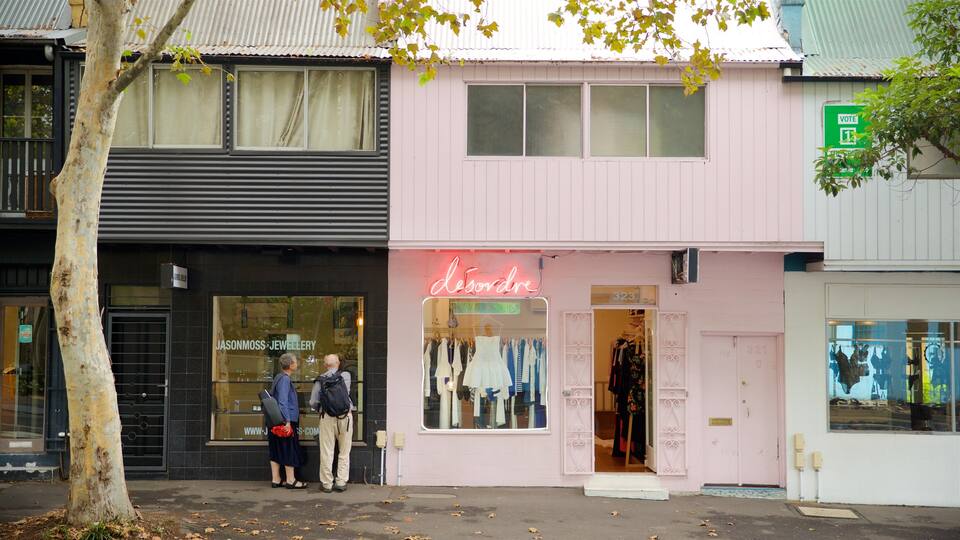 Paddington featuring signage and street scenes as well as a couple