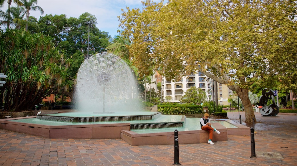 El Alamein Fountain featuring a fountain as well as an individual male