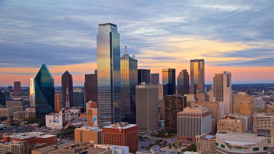 Reunion Tower which includes a city, a sunset and a high rise building