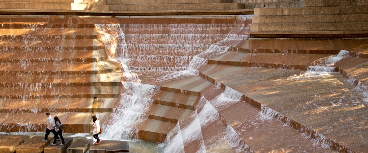 Fort Worth Water Gardens featuring a fountain as well as a small group of people