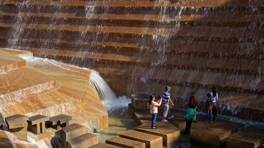 Fort Worth Water Gardens featuring a fountain as well as a small group of people