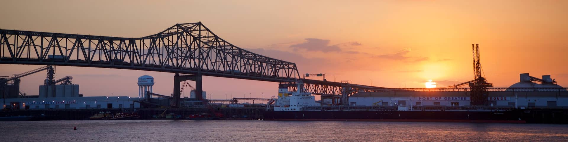 Howard Wilkinson Bridge showing a river or creek, a sunset and a bridge