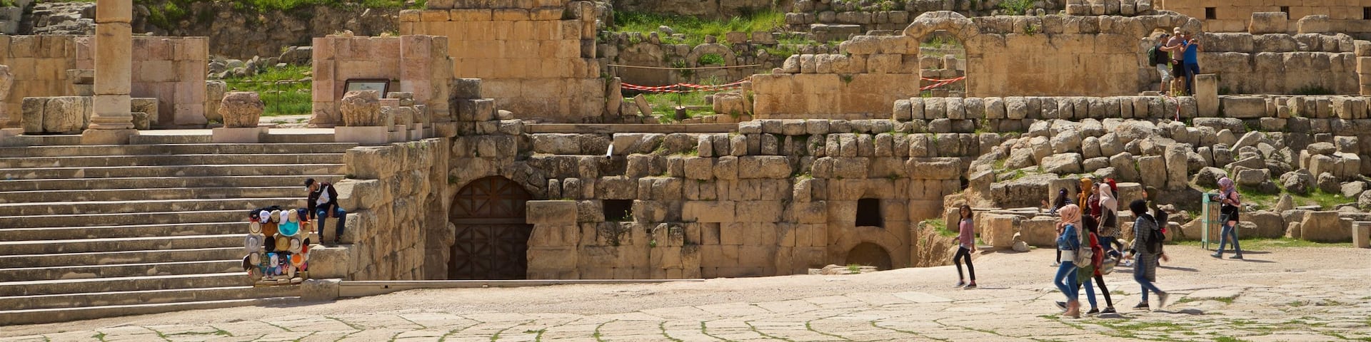 Jerash which includes a ruin and heritage architecture as well as a small group of people