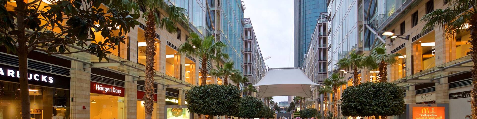 Al Abdali Mall featuring outdoor eating as well as a small group of people